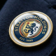 A premium custom resin-domed personalised badges with a 3D raised glossy finish on a corporate suit jacket, manufactured by Dash Dynamics.